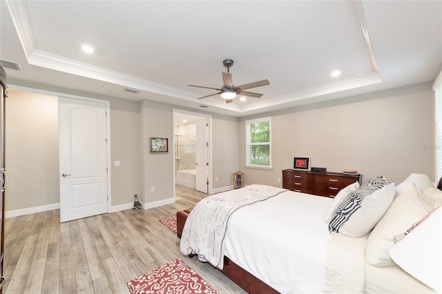 bedroom with a tray ceiling, ornamental molding, light wood-style floors, baseboards, and recessed lighting