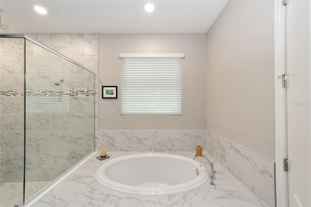 full bathroom featuring a shower stall, a garden tub, and recessed lighting