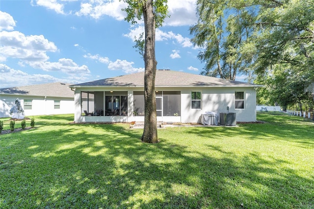 back of house featuring a sunroom, central AC, and a lawn