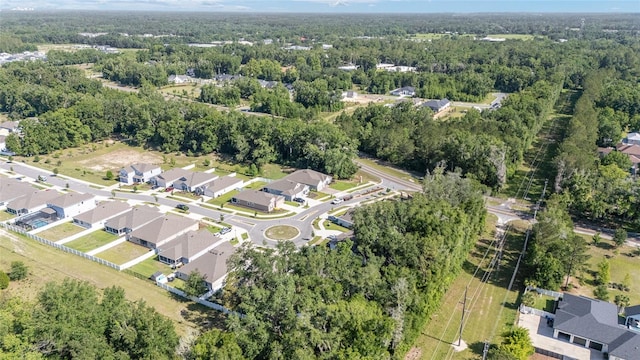 aerial view of property's location with a forest and nearby suburban area