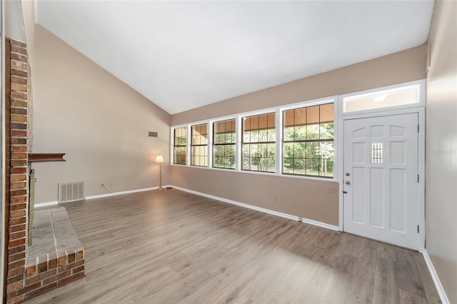 13207 SW Williston Rd, Micanopy, FL 32667 - foyer featuring wood finished floors, baseboards, and high vaulted ceiling