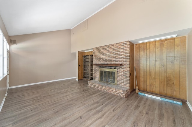 13207 SW Williston Rd, Micanopy, FL 32667 - unfurnished living room featuring wood finished floors, baseboards, and a fireplace