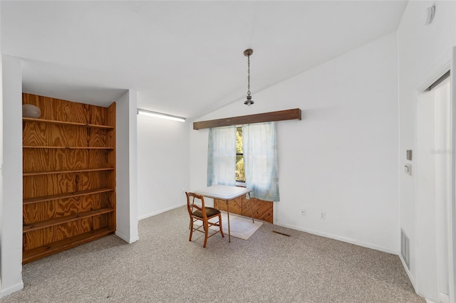 13207 SW Williston Rd, Micanopy, FL 32667 - dining area with carpet floors, lofted ceiling, and baseboards