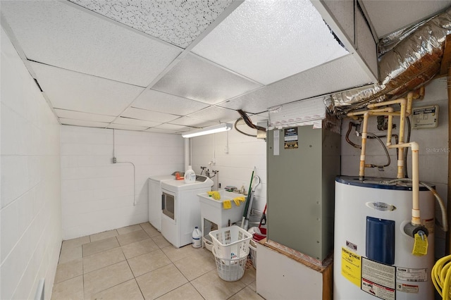 13207 SW Williston Rd, Micanopy, FL 32667 - unfinished basement with water heater, washing machine and dryer, concrete block wall, light tile patterned floors, and a sink