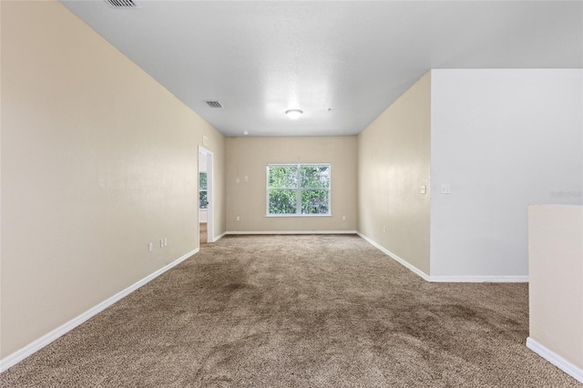 1573 NW 29th Rd Unit 2, Gainesville, FL 32605 - spare room featuring carpet floors and baseboards