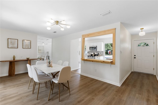 dining area featuring wood finished floors and baseboards