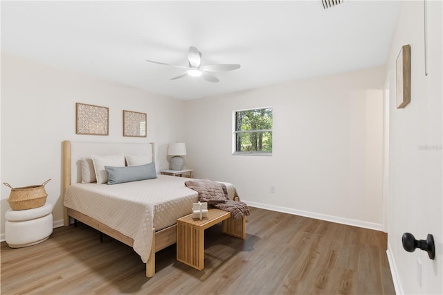 bedroom featuring light wood-type flooring, baseboards, and ceiling fan