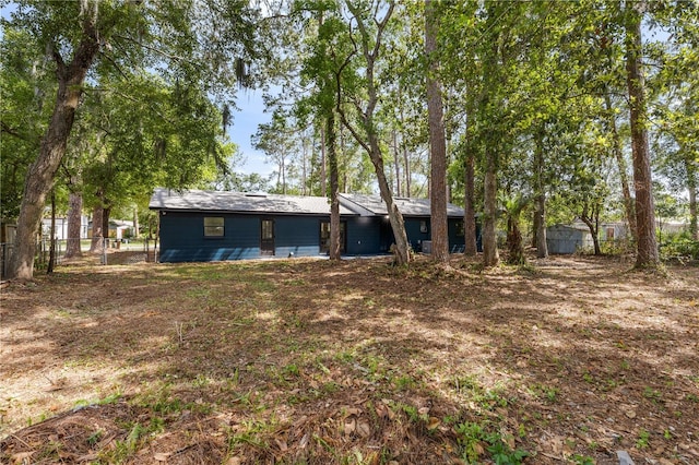 back of house featuring fence