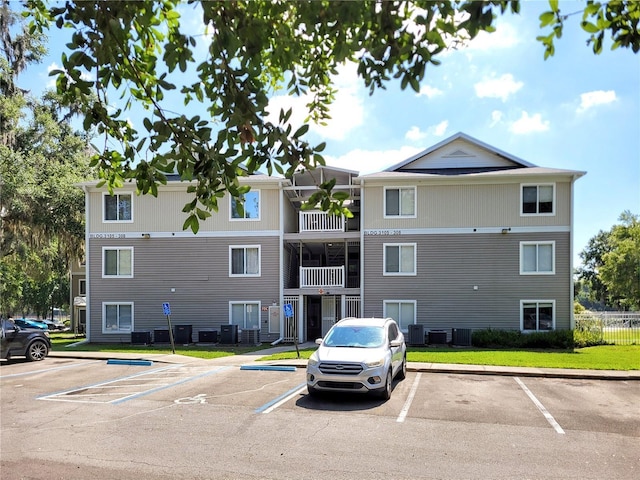 4000 SW 23rd St Unit 3-305, Gainesville, FL 32608 - view of building exterior with uncovered parking and central AC unit