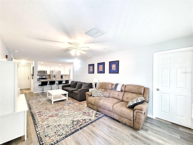 4000 SW 23rd St Unit 3-305, Gainesville, FL 32608 - living room featuring light wood-style flooring and a ceiling fan