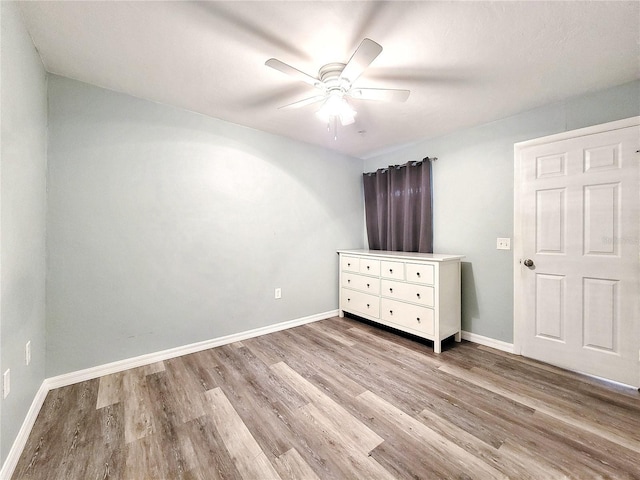 4000 SW 23rd St Unit 3-305, Gainesville, FL 32608 - unfurnished bedroom featuring wood finished floors, baseboards, and ceiling fan