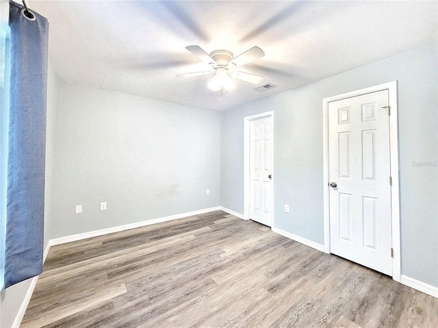4000 SW 23rd St Unit 3-305, Gainesville, FL 32608 - unfurnished bedroom with wood finished floors, baseboards, and ceiling fan