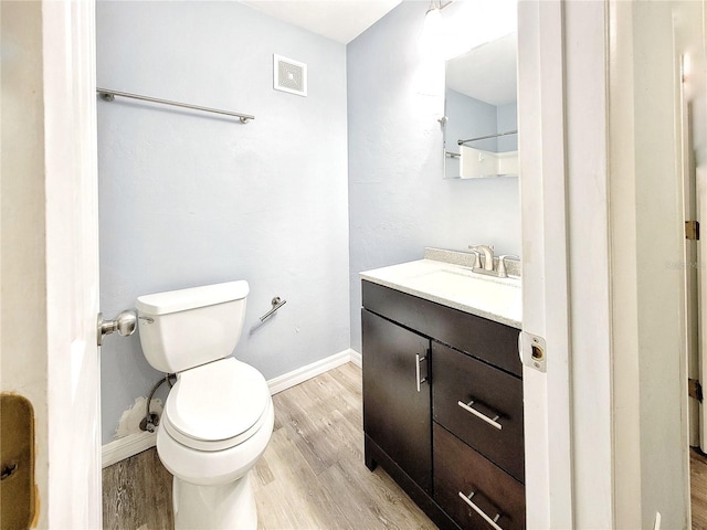 4000 SW 23rd St Unit 3-305, Gainesville, FL 32608 - bathroom featuring vanity, toilet, wood finished floors, and baseboards