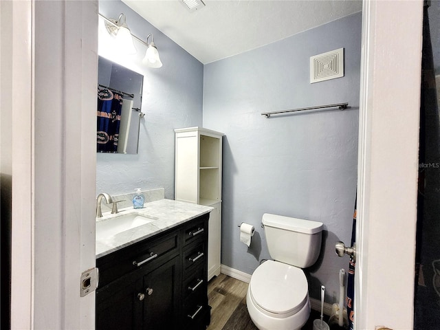 4000 SW 23rd St Unit 3-305, Gainesville, FL 32608 - full bathroom with vanity, wood finished floors, toilet, and baseboards