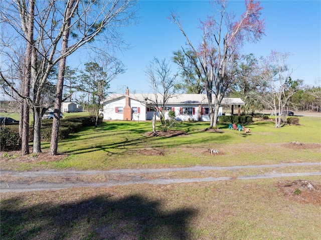 1058 NW County Road 290, Mayo, FL 32066 - view of front of home featuring a front lawn and a chimney