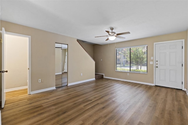 2300 SW 43rd St Unit Q2, Gainesville, FL 32607 - unfurnished living room featuring ceiling fan, wood finished floors, and baseboards