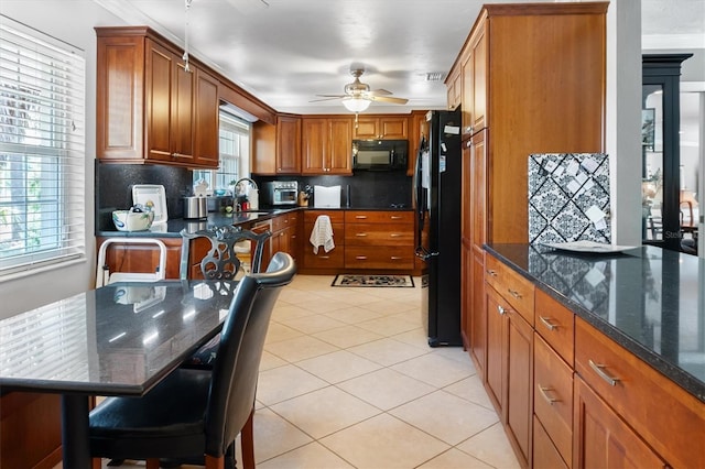 20031 NW County Road 236, High Springs, FL 32643 - kitchen with black appliances, a ceiling fan, light tile patterned floors, decorative backsplash, and brown cabinetry