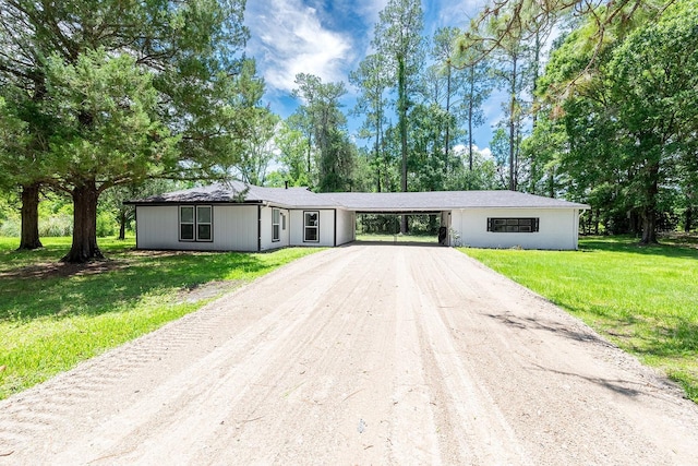 3046 SE 134th St, Starke, FL 32091 - ranch-style house featuring driveway, a carport, and a front lawn