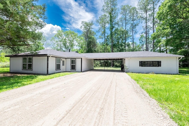 3046 SE 134th St, Starke, FL 32091 - ranch-style home with an attached carport, driveway, and a front yard