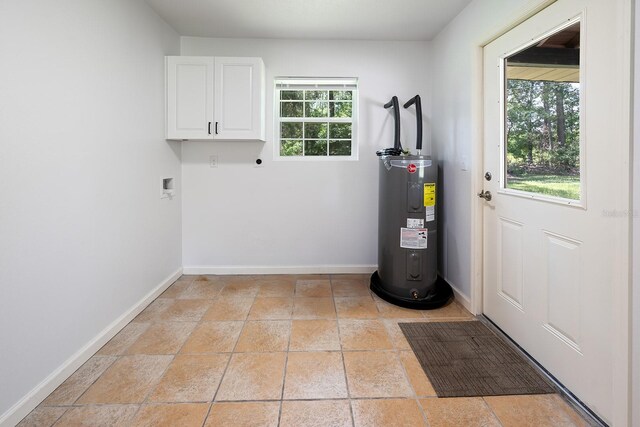3046 SE 134th St, Starke, FL 32091 - laundry area with cabinet space, electric water heater, hookup for an electric dryer, and baseboards