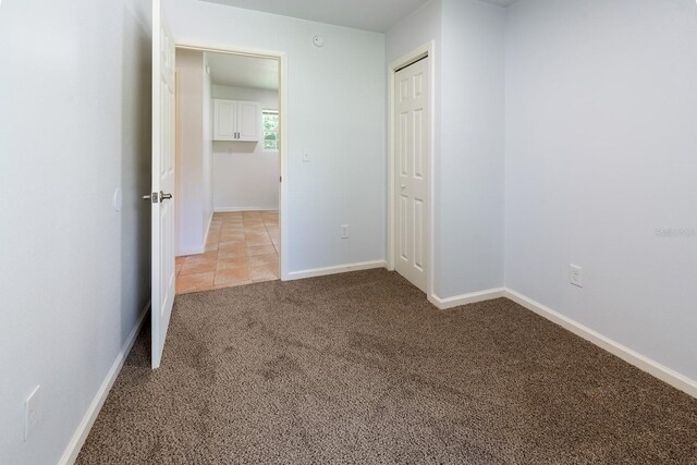 3046 SE 134th St, Starke, FL 32091 - unfurnished bedroom with light colored carpet, baseboards, and a closet