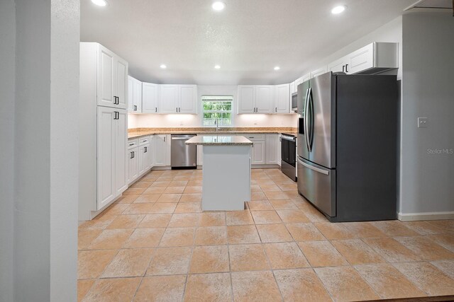 3046 SE 134th St, Starke, FL 32091 - kitchen with appliances with stainless steel finishes, a sink, a center island, recessed lighting, and white cabinets