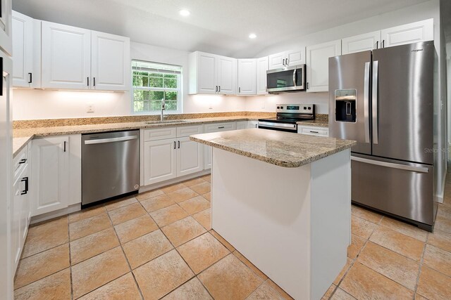 3046 SE 134th St, Starke, FL 32091 - kitchen with stainless steel appliances, white cabinetry, light stone countertops, recessed lighting, and a kitchen island
