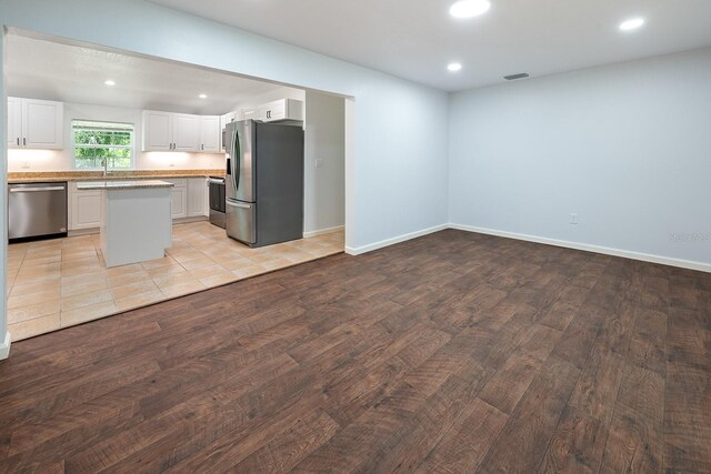 3046 SE 134th St, Starke, FL 32091 - kitchen featuring appliances with stainless steel finishes, light wood-style floors, a sink, white cabinetry, and recessed lighting