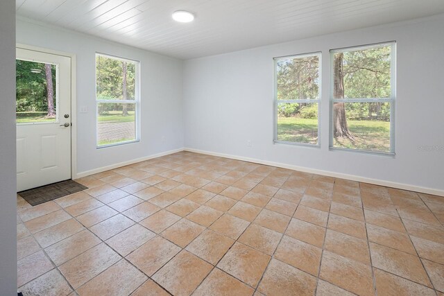 3046 SE 134th St, Starke, FL 32091 - unfurnished room featuring baseboards and light tile patterned floors