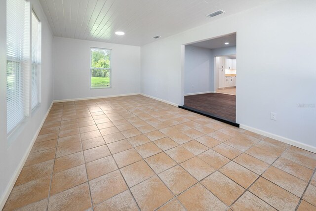 3046 SE 134th St, Starke, FL 32091 - empty room with light tile patterned floors, recessed lighting, and baseboards