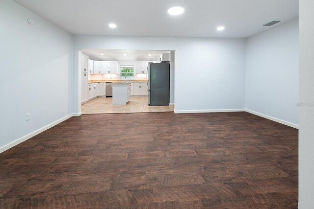3046 SE 134th St, Starke, FL 32091 - unfurnished living room with light wood-type flooring, recessed lighting, and baseboards