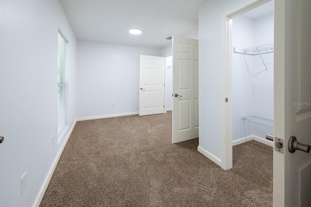 3046 SE 134th St, Starke, FL 32091 - unfurnished bedroom with carpet floors, a walk in closet, baseboards, a closet, and recessed lighting