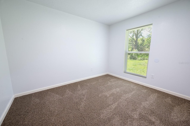 3046 SE 134th St, Starke, FL 32091 - spare room featuring dark carpet and baseboards