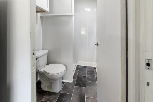 3046 SE 134th St, Starke, FL 32091 - bathroom with toilet, a stall shower, and tile patterned floors