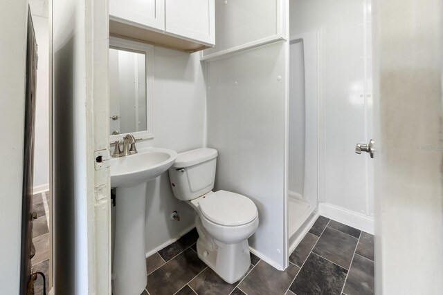 3046 SE 134th St, Starke, FL 32091 - bathroom with toilet, baseboards, and a stall shower
