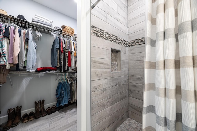 11001 225th Rd, Live Oak, FL 32060 - bathroom with tiled shower, wood finished floors, and a walk in closet
