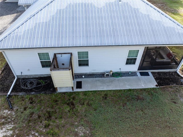 11001 225th Rd, Live Oak, FL 32060 - rear view of house with metal roof, a patio area, and a lawn