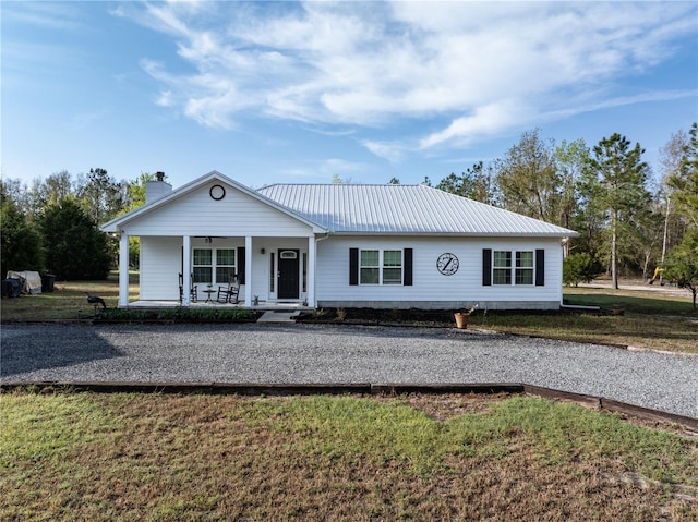 11001 225th Rd, Live Oak, FL 32060 - view of front of property featuring covered porch, metal roof, a front yard, a chimney, and driveway