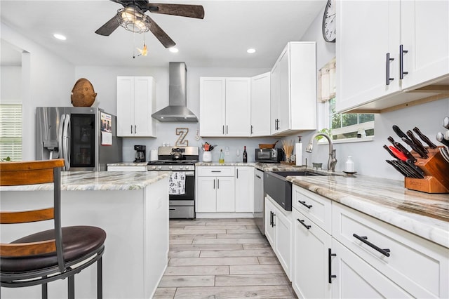 11001 225th Rd, Live Oak, FL 32060 - kitchen with wall chimney range hood, stainless steel appliances, a sink, recessed lighting, and white cabinetry