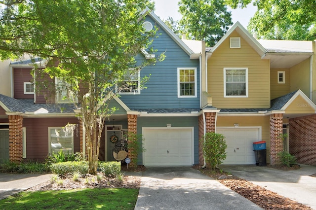 view of property with an attached garage, brick siding, concrete driveway, and a shingled roof