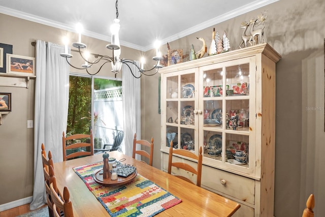 dining room featuring a chandelier and crown molding
