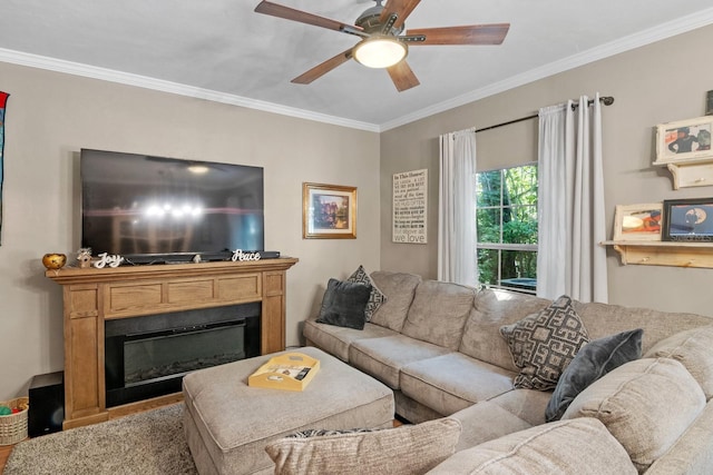 living room with crown molding, a glass covered fireplace, and ceiling fan