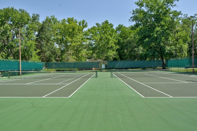view of tennis court featuring community basketball court