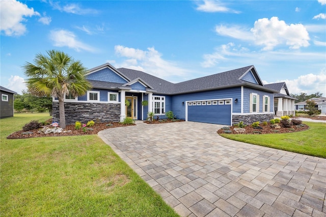 1084 NW 134th Way, Newberry, FL 32669 - craftsman-style house featuring stone siding, an attached garage, decorative driveway, and a front lawn