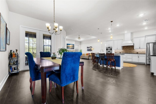 1084 NW 134th Way, Newberry, FL 32669 - dining space with dark wood finished floors, a chandelier, recessed lighting, and baseboards