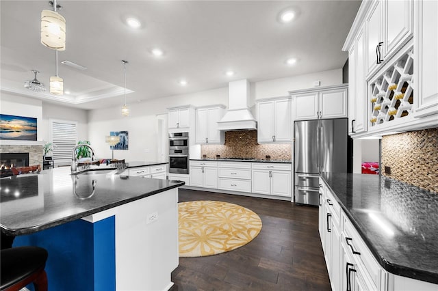 1084 NW 134th Way, Newberry, FL 32669 - kitchen with appliances with stainless steel finishes, premium range hood, a sink, recessed lighting, and dark wood finished floors