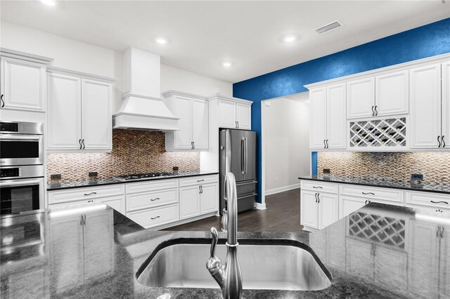 1084 NW 134th Way, Newberry, FL 32669 - kitchen featuring stainless steel appliances, custom exhaust hood, a sink, white cabinets, and recessed lighting