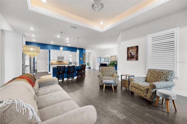 1084 NW 134th Way, Newberry, FL 32669 - living area with a chandelier, dark wood-type flooring, recessed lighting, a raised ceiling, and baseboards
