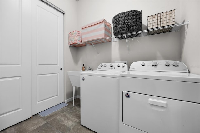 1084 NW 134th Way, Newberry, FL 32669 - laundry area with washing machine and clothes dryer, stone finish floors, and baseboards