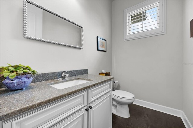 1084 NW 134th Way, Newberry, FL 32669 - bathroom featuring toilet, vanity, and baseboards